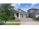Charming single-Gathering home featuring a two-car garage and covered entryway at 5511 Orange Orchard Dr, Winter Garden, FL 34787