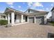 Inviting single-story home with a brick driveway, a covered porch, and an attached garage at 5511 Orange Orchard Dr, Winter Garden, FL 34787