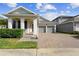 Charming single-story home featuring a brick driveway and attached two-car garage at 5511 Orange Orchard Dr, Winter Garden, FL 34787