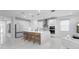 Modern, white kitchen featuring an island with seating, stainless steel appliances, and pendant lighting at 5511 Orange Orchard Dr, Winter Garden, FL 34787