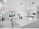 Open kitchen area with an island, sink, and view of the living room and dining area at 5511 Orange Orchard Dr, Winter Garden, FL 34787