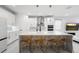Bright, white kitchen featuring an island with seating, pendant lighting, and modern appliances at 5511 Orange Orchard Dr, Winter Garden, FL 34787