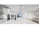 Open-concept kitchen with a large island, modern appliances, and views of the living and dining areas at 5511 Orange Orchard Dr, Winter Garden, FL 34787
