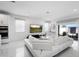 Bright, open living space featuring a large TV, comfortable seating, and access to outdoor patio at 5511 Orange Orchard Dr, Winter Garden, FL 34787