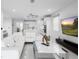 Open-concept living room with sleek white tile, modern furnishings, and a view of the kitchen at 5511 Orange Orchard Dr, Winter Garden, FL 34787