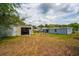 The spacious backyard features two buildings and ample outdoor space for recreation and storage, enhancing the property's functionality at 55119 5Th St, Astor, FL 32102