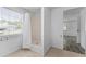 Bathroom features a stand up shower with white shower curtain, tile floors and natural light at 55119 5Th St, Astor, FL 32102