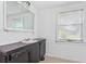 Bathroom with a dark vanity, granite counters, and a window bringing in natural light at 55119 5Th St, Astor, FL 32102