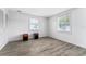Empty bedroom featuring laminate floors, light walls, and two windows at 55119 5Th St, Astor, FL 32102