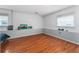 Bedroom with wood-look floors, a two-toned paint scheme, and a large window at 55119 5Th St, Astor, FL 32102