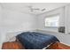 Bedroom with wood-look floors, ceiling fan and natural light from a sunny window at 55119 5Th St, Astor, FL 32102
