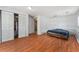 Bedroom with wood-look floors, a large closet, and neutral walls at 55119 5Th St, Astor, FL 32102