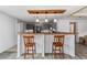 Modern kitchen with gray cabinets, pendant lighting, and a breakfast bar with seating at 55119 5Th St, Astor, FL 32102