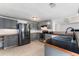 A bright kitchen featuring grey cabinets, stainless appliances, and ample counter space, offers a blend of style and functionality at 55119 5Th St, Astor, FL 32102