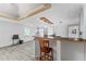 Bright living space featuring wood-look floors, a kitchen bar, and white walls at 55119 5Th St, Astor, FL 32102