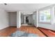 Bright living area with hardwood flooring and a glimpse into the kitchen provides open sight lines for entertaining at 55119 5Th St, Astor, FL 32102