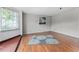 The living room is bright and airy, featuring hardwood floors, a window and a cozy rug at 55119 5Th St, Astor, FL 32102