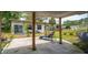 This covered patio offers a charming outdoor space with a cozy lounge chair and shade, perfect for relaxation at 55119 5Th St, Astor, FL 32102