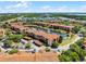 Aerial view of a residential area with apartments, a pond, lush landscaping, and parking lots at 5530 Metrowest Blvd # 309, Orlando, FL 32811