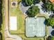 Aerial view of tennis court and playground area in a residential community at 5530 Metrowest Blvd # 309, Orlando, FL 32811