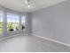 Bright bedroom with ceiling fan and large windows offering views at 5530 Metrowest Blvd # 309, Orlando, FL 32811