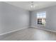 Bedroom featuring a large window, neutral walls, and bright flooring at 5530 Metrowest Blvd # 309, Orlando, FL 32811