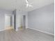 Spacious bedroom with modern ceiling fan, neutral walls, and a closet at 5530 Metrowest Blvd # 309, Orlando, FL 32811