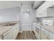 Open kitchen design with stainless steel appliances, wood-look flooring, and ample counter space at 5530 Metrowest Blvd # 309, Orlando, FL 32811