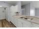 Bright kitchen featuring stainless steel sink, white cabinets, and wood-look flooring at 5530 Metrowest Blvd # 309, Orlando, FL 32811