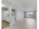 Open-concept living room featuring modern flooring, neutral paint, and an opening to the kitchen area at 5530 Metrowest Blvd # 309, Orlando, FL 32811