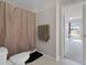 Cozy bathroom with shower, toilet, tile flooring, and neutral wall color at 5566 Metrowest Blvd # 304, Orlando, FL 32811