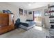 Well-lit bedroom with a neutral carpet, a ceiling fan, and a large window at 5566 Metrowest Blvd # 304, Orlando, FL 32811