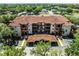 Exterior shot of the property showing the architecture, multiple stories, and tile roof at 5566 Metrowest Blvd # 304, Orlando, FL 32811