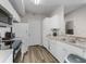 Clean kitchen offering white appliances, ample cabinet space, and modern countertops at 5566 Metrowest Blvd # 304, Orlando, FL 32811