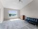 Spacious living room with vaulted ceiling, large window, neutral carpet, and modern furnishings at 5566 Metrowest Blvd # 304, Orlando, FL 32811