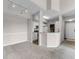 Inviting living area with bar seating, updated track lighting, and seamless flow to the kitchen at 5566 Metrowest Blvd # 304, Orlando, FL 32811