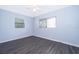This bedroom offers gray vinyl floors, fresh light blue paint, a ceiling fan, and a window for natural light at 5601 Andora St, Orlando, FL 32807