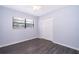 This bedroom offers gray vinyl floors, fresh light blue paint, a ceiling fan, and a window for natural light at 5601 Andora St, Orlando, FL 32807