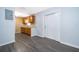 A well-lit kitchen with gray wood laminate flooring, wooden cabinets and white door at 5601 Andora St, Orlando, FL 32807