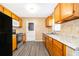 Updated kitchen boasts wood cabinets, granite countertops, stainless steel appliances and gray flooring at 5601 Andora St, Orlando, FL 32807