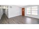 A bright living room with a modern gray wood laminate flooring at 5601 Andora St, Orlando, FL 32807