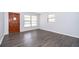 Spacious living room with a modern gray wood laminate flooring and lots of natural light at 5601 Andora St, Orlando, FL 32807