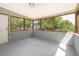 Large screened porch with concrete floors and walls of windows for enjoying the outdoors at 5601 Andora St, Orlando, FL 32807