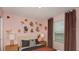 Charming bedroom featuring stylish decor, warm lighting, and soft, pink walls at 5657 Loggia Ln, Kissimmee, FL 34758