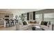 Inviting living room adjacent to modern kitchen and dining area, with plentiful natural light at 5657 Loggia Ln, Kissimmee, FL 34758