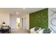 Comfortable loft area featuring white chairs, unique wall decor, and desk at 5657 Loggia Ln, Kissimmee, FL 34758
