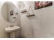 Half bathroom featuring a pedestal sink and decorative mirror at 6822 Habitat Dr, Harmony, FL 34773
