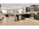 Open-concept kitchen featuring dark cabinetry, stainless steel appliances, and a spacious island overlooking living areas at 6822 Habitat Dr, Harmony, FL 34773