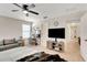 Primary bedroom with a workstation, ceiling fan and a tv at 6822 Habitat Dr, Harmony, FL 34773