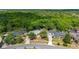 An aerial view shows this home and neighborhood backing up to mature trees at 694 Tuscora Dr, Winter Springs, FL 32708
